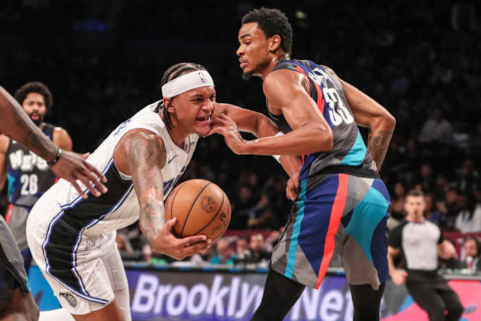 Orlando Magic forward Paolo Banchero muscles through contact from Brooklyn Nets center Nic Clayton (33)
